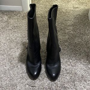 Black boots. Mid-calf height. 3 in heal. Zipper design is functional and pretty.